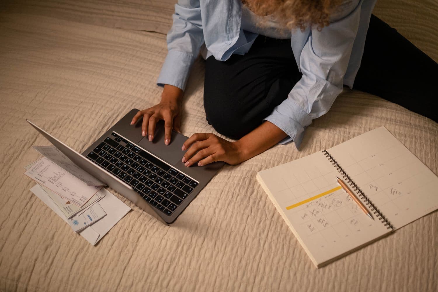 A web designer planning client work beside a laptop